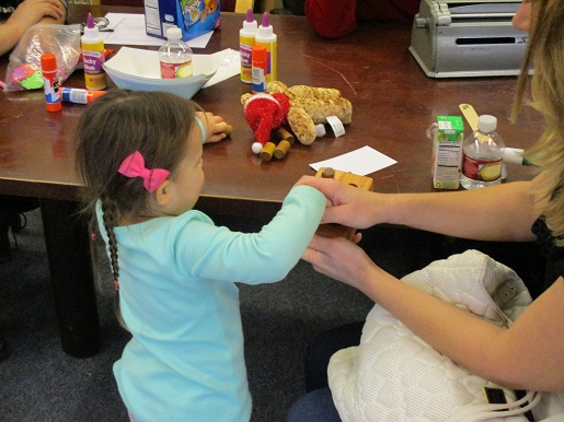 A mother and her blind child doing Braille